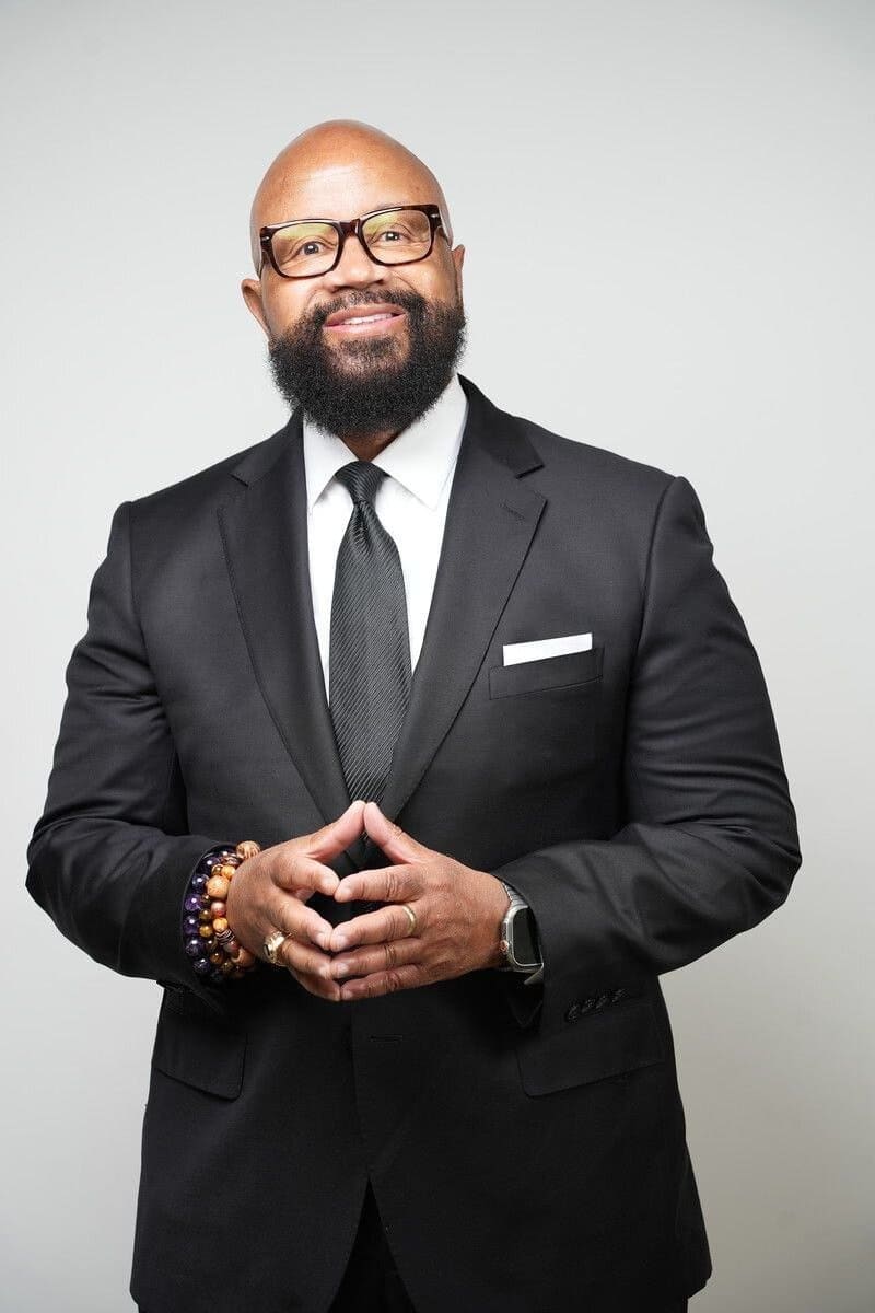 Portrait of Bishop Donald Hilliard, Jr. standing in a dark suit